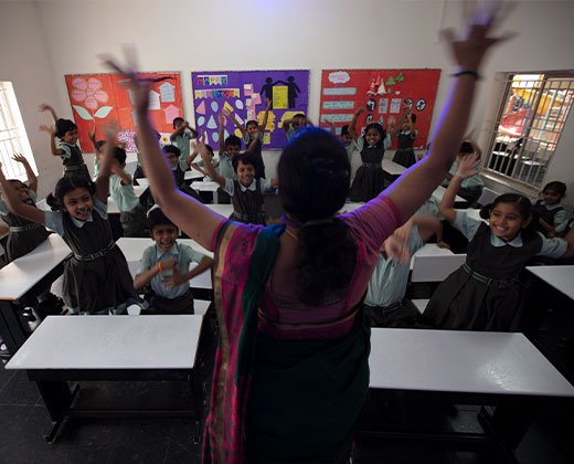 Students learning with a teacher at National Model School in Coimbatore